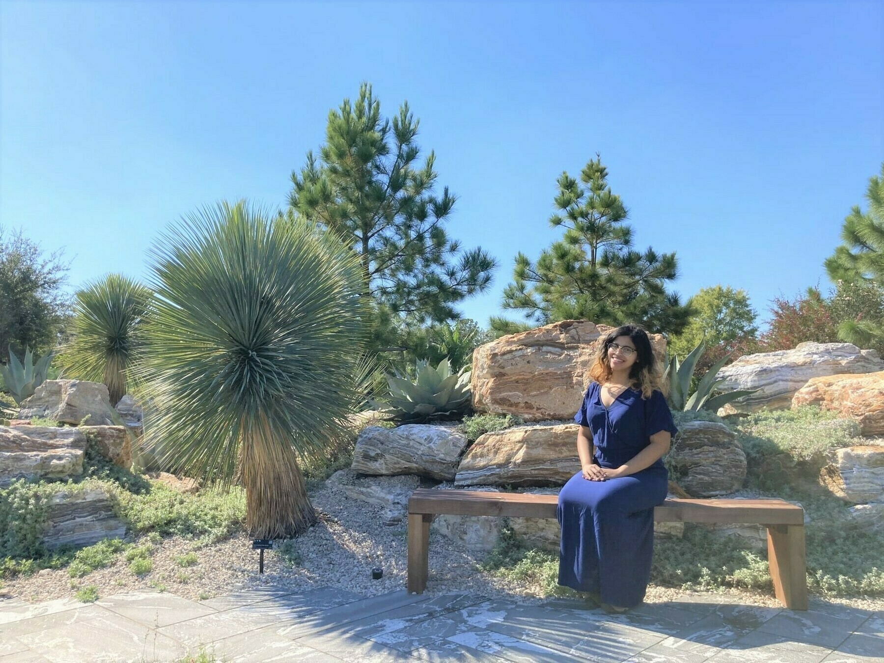 Me in a blue dress sitting on a rock